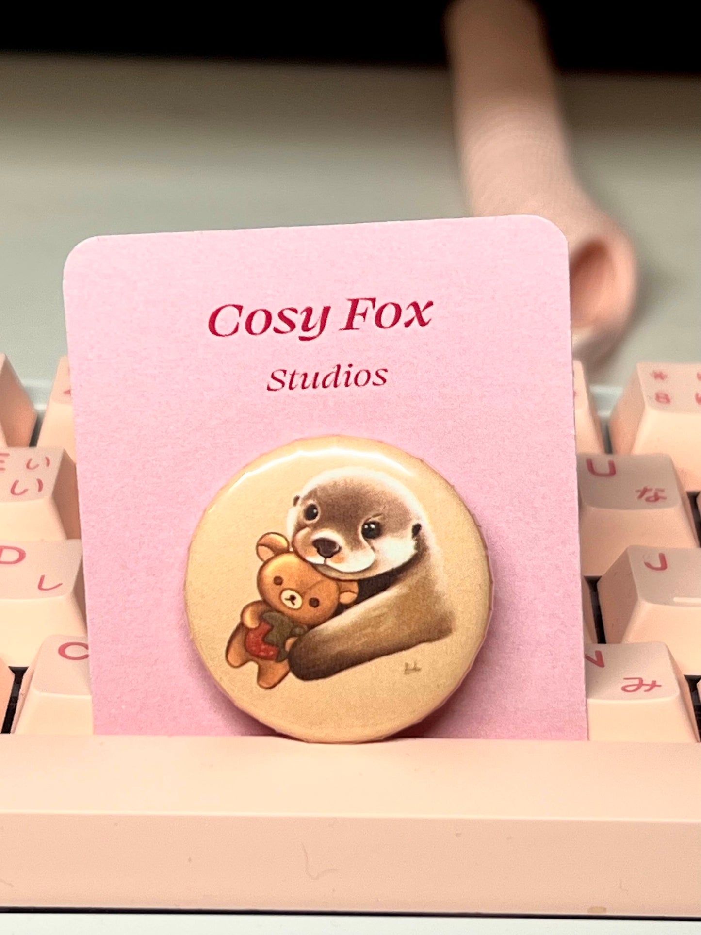 Cute otter holding rilakkuma plushie badge